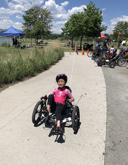 BELL student rides a recumbent bicycle